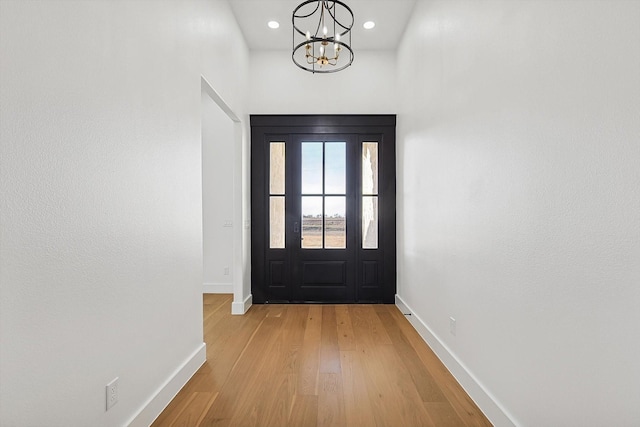 entryway with a notable chandelier and light wood-type flooring