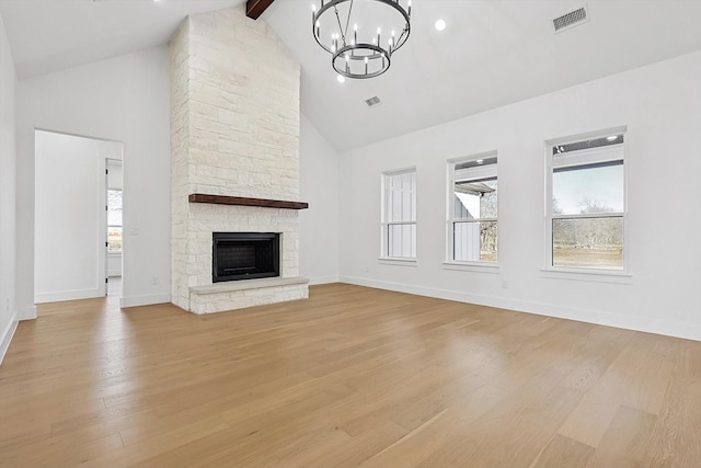 unfurnished living room with beamed ceiling, high vaulted ceiling, a fireplace, and light wood-type flooring