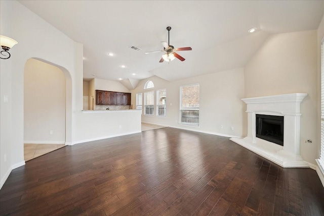 unfurnished living room with dark wood-type flooring, vaulted ceiling, and ceiling fan