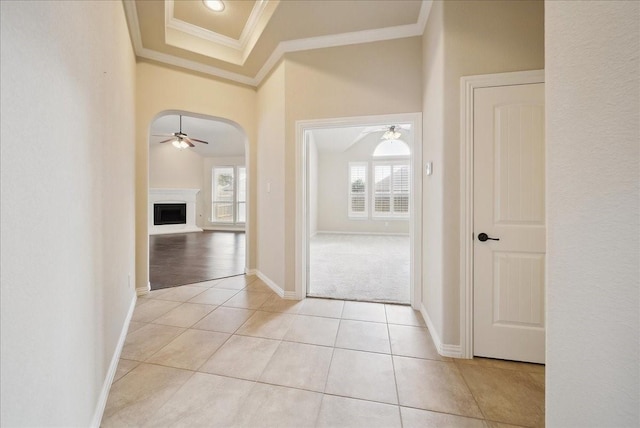 hall with crown molding and light tile patterned flooring