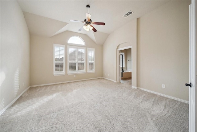 carpeted empty room with vaulted ceiling and ceiling fan