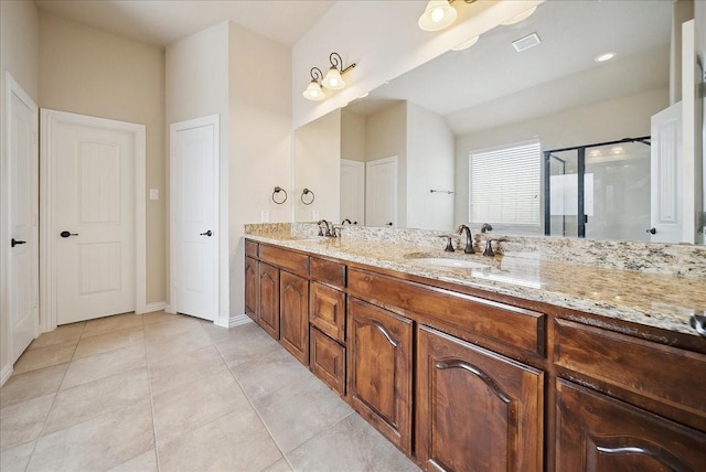 bathroom with walk in shower, vanity, and tile patterned flooring