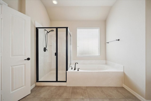 bathroom with lofted ceiling, tile patterned floors, and shower with separate bathtub