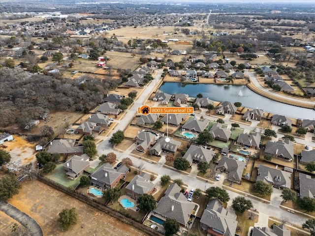 birds eye view of property with a water view