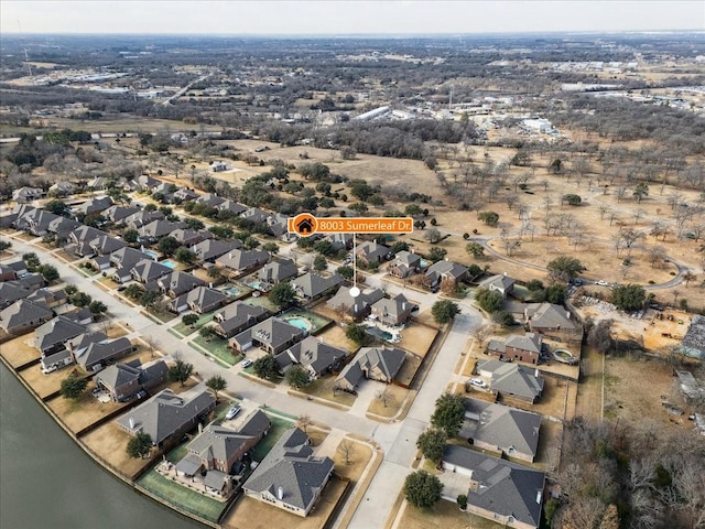 drone / aerial view with a water view and a residential view