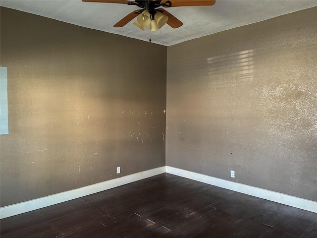 empty room featuring ceiling fan and dark hardwood / wood-style flooring