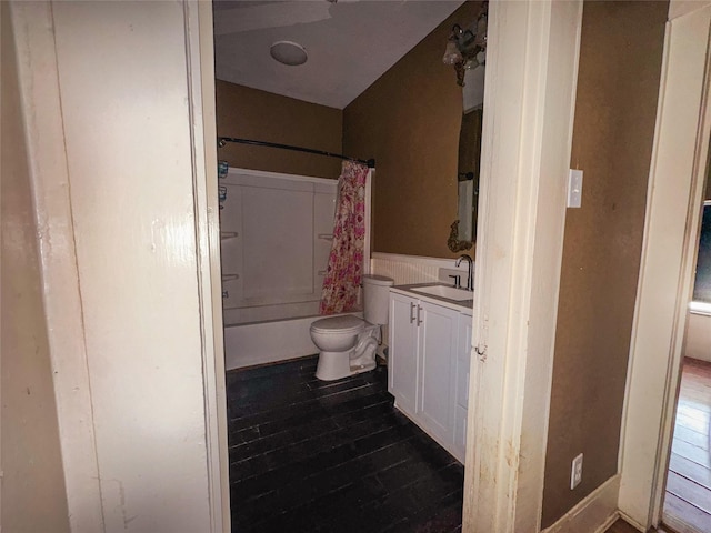 full bathroom featuring shower / bathtub combination with curtain, vanity, toilet, and hardwood / wood-style floors