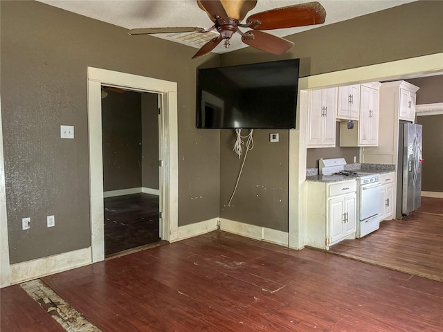 kitchen with dark hardwood / wood-style floors, white cabinets, ceiling fan, stainless steel fridge with ice dispenser, and white gas stove