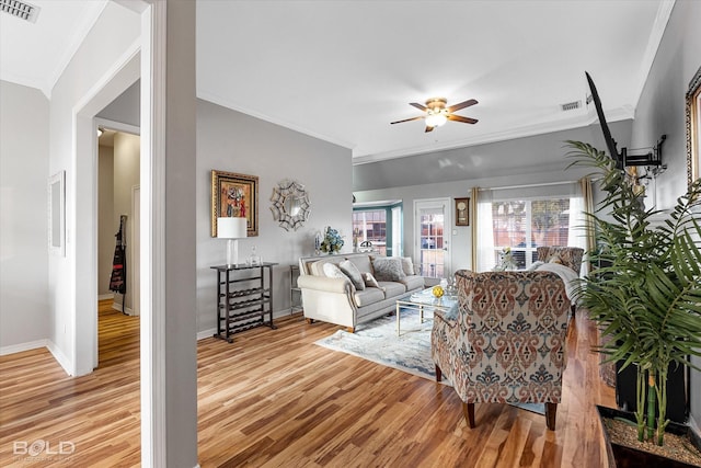 living room with crown molding, ceiling fan, and light hardwood / wood-style flooring