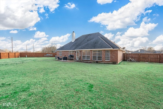 back of house featuring a yard and a patio area