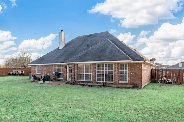 back of property featuring a lawn and a patio