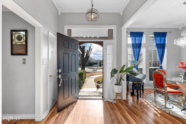 entryway featuring ornamental molding and hardwood / wood-style floors