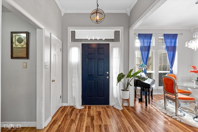 foyer with ornamental molding and wood-type flooring