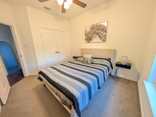 carpeted bedroom featuring ceiling fan and a closet