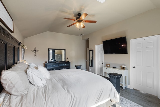 bedroom with ceiling fan, lofted ceiling, and light hardwood / wood-style floors