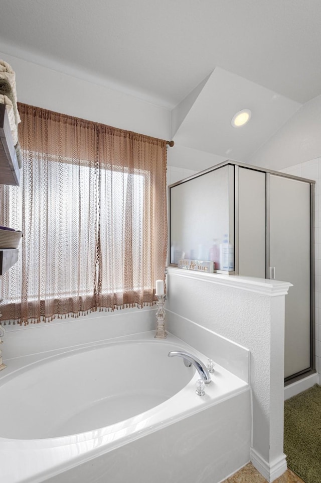 bathroom featuring shower with separate bathtub