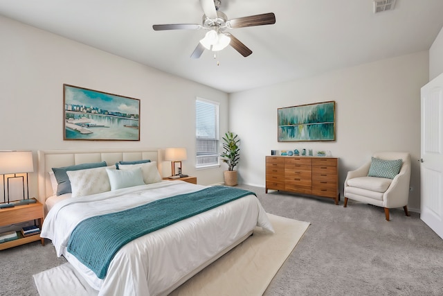 bedroom with carpet floors, visible vents, and ceiling fan