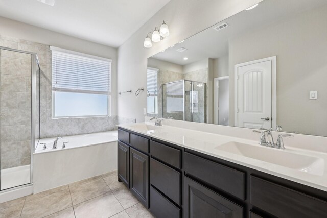 full bathroom with a stall shower, visible vents, a sink, and tile patterned floors