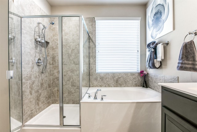 full bathroom with a stall shower, a garden tub, and vanity