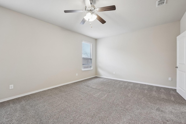 carpeted empty room featuring a ceiling fan, visible vents, and baseboards