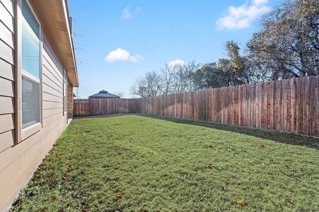 view of yard with a fenced backyard