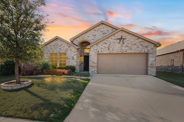 view of front of home with a garage, concrete driveway, and brick siding