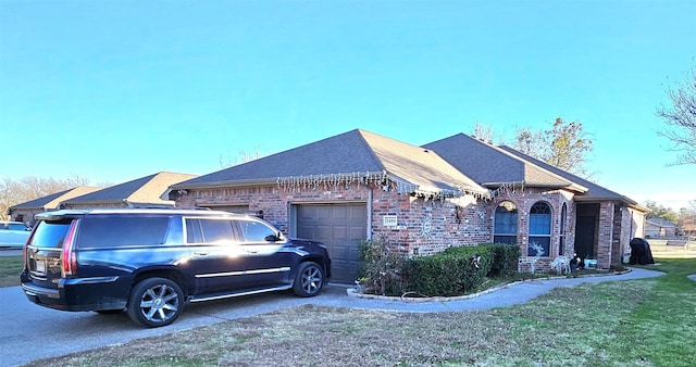 view of front facade with a garage and a front lawn