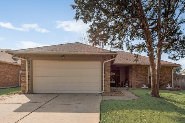 ranch-style house featuring a garage and a front yard