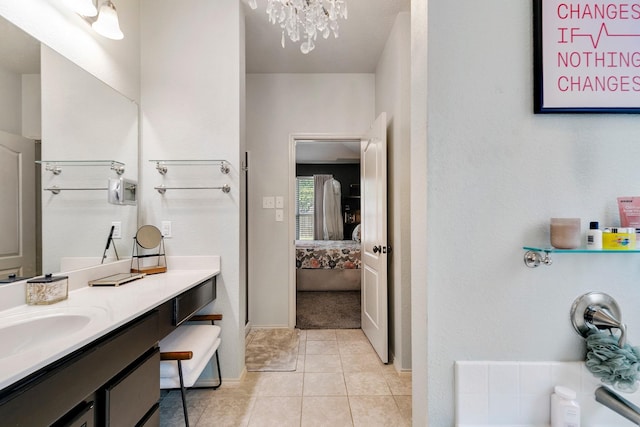 bathroom with vanity, tile patterned floors, and a chandelier