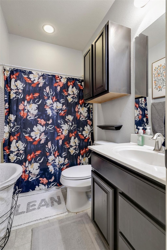 bathroom with tile patterned floors, vanity, and toilet