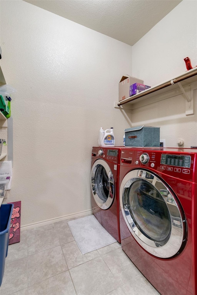 washroom featuring separate washer and dryer and light tile patterned floors