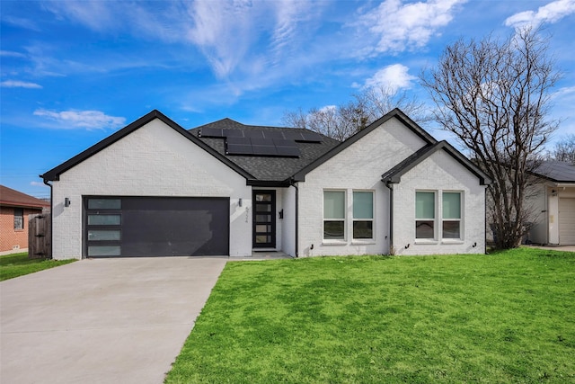 view of front facade with a garage, a front lawn, and solar panels