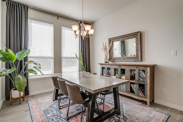 dining space with a notable chandelier and light wood-type flooring