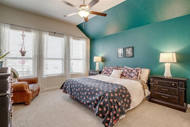 carpeted bedroom featuring lofted ceiling and ceiling fan