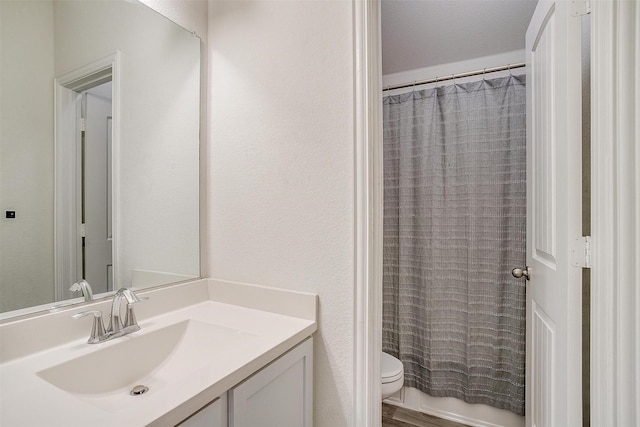 full bathroom featuring vanity, shower / tub combo with curtain, and toilet