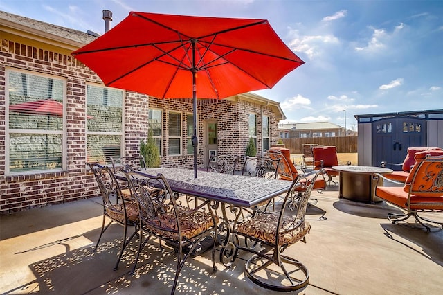 view of patio / terrace featuring a storage unit and an outdoor fire pit