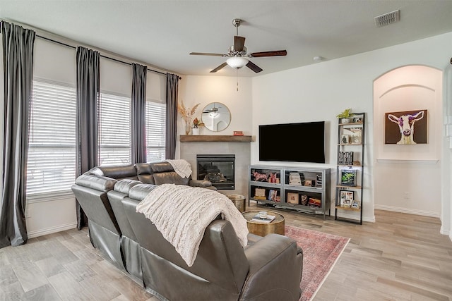 living room with ceiling fan and light hardwood / wood-style floors