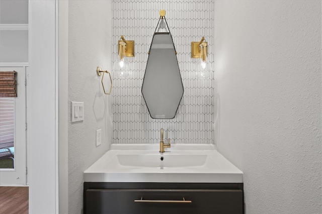 bathroom with crown molding and vanity