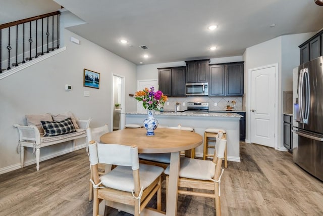 dining area with sink and light hardwood / wood-style flooring