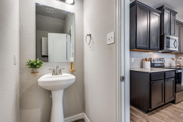 bathroom with wood-type flooring and backsplash