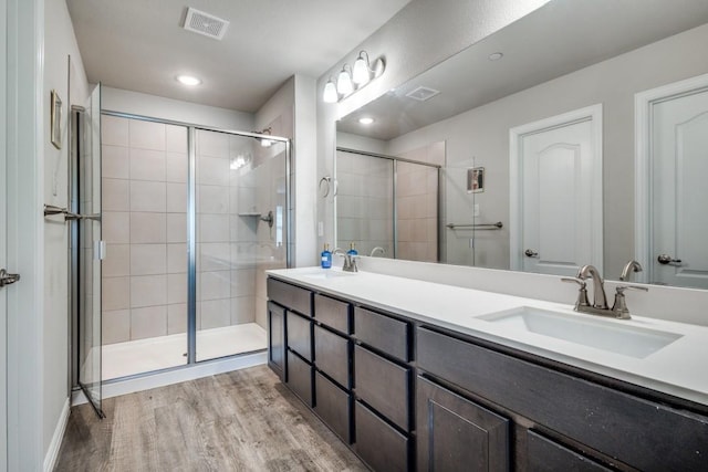 bathroom with vanity, hardwood / wood-style floors, and an enclosed shower