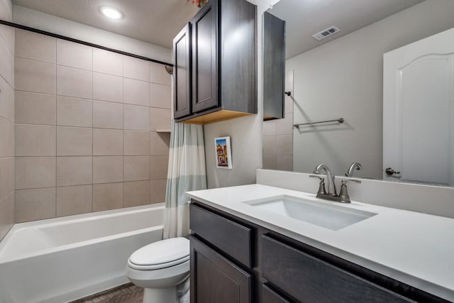 full bathroom featuring hardwood / wood-style flooring, shower / tub combo with curtain, vanity, and toilet