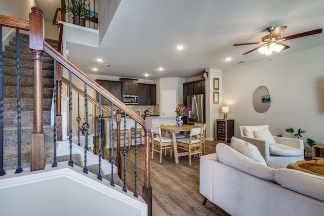 living room with ceiling fan and wood-type flooring