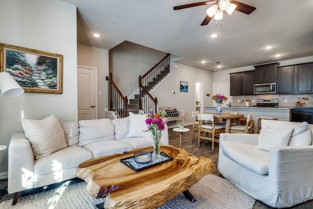 living room featuring wood-type flooring and ceiling fan