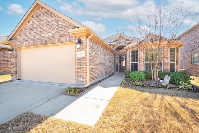 view of front of home featuring brick siding, concrete driveway, and a garage