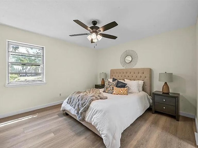 bedroom with ceiling fan and light hardwood / wood-style floors