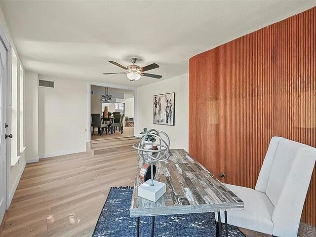 dining room with hardwood / wood-style flooring and ceiling fan