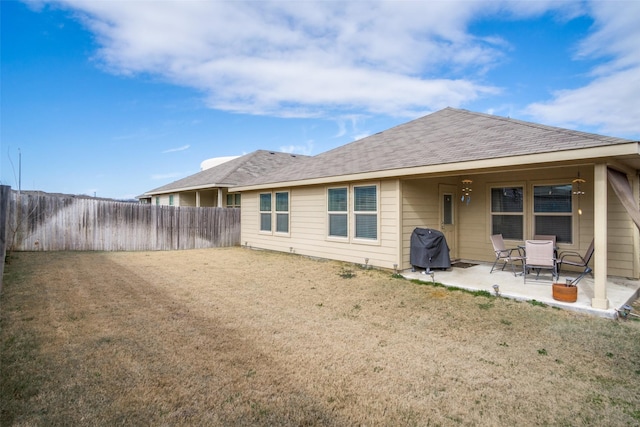 rear view of house with a yard and a patio