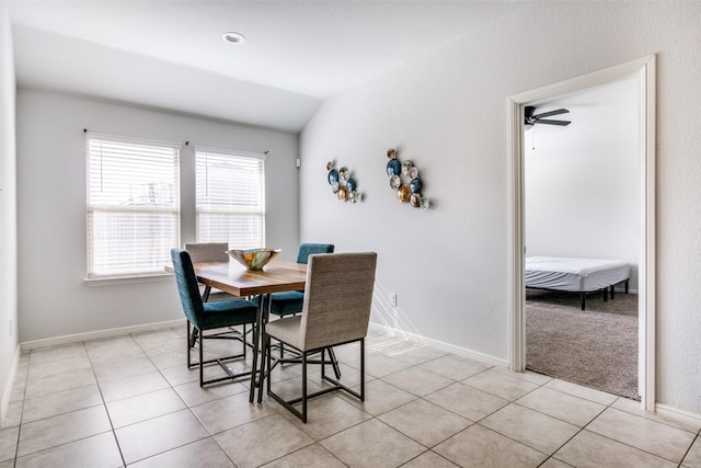 dining room with lofted ceiling and light tile patterned floors