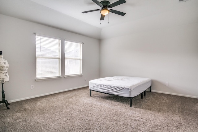 bedroom featuring vaulted ceiling, ceiling fan, and carpet flooring